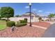 Lovely single-story home boasting neat landscaping, a lamp post, and a well-maintained lawn with decorative rocks at 2128 Alfredo Ave, Lady Lake, FL 32159