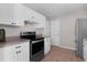 Bright kitchen with white cabinets, stainless steel appliances, and tile flooring at 2128 Alfredo Ave, Lady Lake, FL 32159