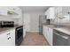 Well-equipped kitchen featuring white cabinetry and stainless steel appliances at 2128 Alfredo Ave, Lady Lake, FL 32159