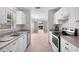 Well-lit kitchen featuring white cabinets, tile flooring, and stainless steel appliances at 2128 Alfredo Ave, Lady Lake, FL 32159