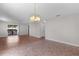 Bright living room featuring wood floors, a ceiling fan and an elegant chandelier at 2128 Alfredo Ave, Lady Lake, FL 32159