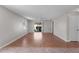 Open-concept living room with wood flooring and sliding glass doors to the backyard at 2128 Alfredo Ave, Lady Lake, FL 32159