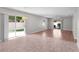 Spacious living room with tile and hardwood flooring, and sliding glass doors to the backyard at 2128 Alfredo Ave, Lady Lake, FL 32159