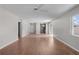 Large living room with hardwood flooring, ceiling fan, and multiple entryways at 2128 Alfredo Ave, Lady Lake, FL 32159
