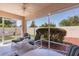 Enjoy the outdoors from this screened patio with comfortable seating and a ceiling fan at 2128 Alfredo Ave, Lady Lake, FL 32159