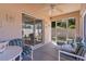 Cozy screened patio with furniture, ceiling fan, and sliding glass door to the backyard at 2128 Alfredo Ave, Lady Lake, FL 32159