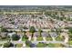 Community aerial view of single Gathering homes on manicured lots, and neighborhood golf course at 2139 Kaylee Dr, The Villages, FL 32162