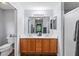 Bathroom featuring a double sink vanity with a large mirror and modern lighting fixtures at 2139 Kaylee Dr, The Villages, FL 32162