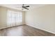 Bright bedroom with luxury vinyl floors, ceiling fan, and sheer curtains at 2139 Kaylee Dr, The Villages, FL 32162