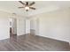 Large bedroom with luxury vinyl floors, neutral walls, and connecting bathroom at 2139 Kaylee Dr, The Villages, FL 32162