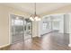 Bright dining area features wood floors, updated lighting fixture, and access to a screened-in lanai at 2139 Kaylee Dr, The Villages, FL 32162