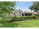 Home exterior with a screened lanai and lush landscaping at 2139 Kaylee Dr, The Villages, FL 32162