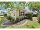 Charming home featuring neatly landscaped shrubs and decorative rock beds surrounding its foundation at 2139 Kaylee Dr, The Villages, FL 32162