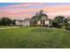 A lovely single-story home with an attached garage, set against a vibrant sky and lush green lawn at 2139 Kaylee Dr, The Villages, FL 32162