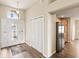Welcoming foyer featuring laminate wood flooring, a closet, and views of the kitchen and dining area at 2139 Kaylee Dr, The Villages, FL 32162