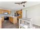Spacious kitchen featuring stainless steel appliances and a center island with wooden cabinets at 2139 Kaylee Dr, The Villages, FL 32162
