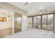 Large screened lanai with ceiling fans and a sliding door leading to the kitchen at 2139 Kaylee Dr, The Villages, FL 32162