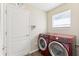 Laundry room featuring a modern washer and dryer with a window for natural light at 2139 Kaylee Dr, The Villages, FL 32162