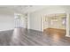 Open floor plan showcasing living space with laminate wood floors, high ceilings, and access to the entryway at 2139 Kaylee Dr, The Villages, FL 32162