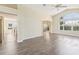 Open-concept living room features laminate wood flooring, vaulted ceilings and views to the kitchen and lanai at 2139 Kaylee Dr, The Villages, FL 32162