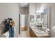 Bright bathroom featuring double sinks, tiled floors, and decorative accents at 2293 Wayland St, The Villages, FL 32162