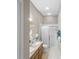 Bathroom with glass enclosed shower, dual sinks, and tile flooring at 2293 Wayland St, The Villages, FL 32162
