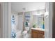 Well-lit bathroom with tub, shower, and decorative accents at 2293 Wayland St, The Villages, FL 32162