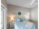 A bedroom with neutral walls, carpet flooring, a ceiling fan, and a sliding door that leads to the outside at 2293 Wayland St, The Villages, FL 32162