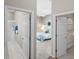 A look from the hallway into the main bedroom with view to the ensuite bath and walk-in closet at 2293 Wayland St, The Villages, FL 32162