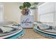Well-appointed dining table featuring a 'Welcome Home' centerpiece, inviting wicker chairs, and natural light at 2293 Wayland St, The Villages, FL 32162