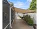 Exterior view of home with awning-covered screened patio and lush landscaping at 2293 Wayland St, The Villages, FL 32162