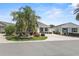 Beautiful single-story home with lush tropical landscaping and well-manicured lawn at 2293 Wayland St, The Villages, FL 32162