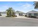 Charming single-story home with a well-manicured lawn and lush tropical landscaping at 2293 Wayland St, The Villages, FL 32162