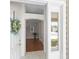 Welcoming foyer showcasing a hardwood floor, decorative wreath, and a glimpse into the home's interior at 2293 Wayland St, The Villages, FL 32162