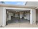A spacious garage with storage cabinets, utility sink, and ample room for parking and projects at 2293 Wayland St, The Villages, FL 32162