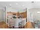 Bright kitchen featuring wood cabinets, granite countertops, stainless steel appliances, and a breakfast bar with seating at 2293 Wayland St, The Villages, FL 32162
