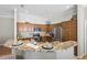 Beautiful kitchen featuring stainless steel appliances, granite countertops, wood cabinets and a large breakfast bar area at 2293 Wayland St, The Villages, FL 32162