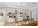 Spacious living room with hardwood floors, built-in shelving, and a cozy seating area at 2293 Wayland St, The Villages, FL 32162