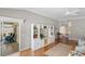 Open living space featuring built-in shelving, hardwood floors, and access to an outdoor patio at 2293 Wayland St, The Villages, FL 32162