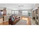 Bright and airy living area with hardwood floors, a comfortable leather sofa, and ample natural light at 2293 Wayland St, The Villages, FL 32162