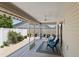 Relaxing screened-in patio with tile floors, ceiling fan, outdoor chairs, and nice plantings at 2293 Wayland St, The Villages, FL 32162