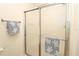 Bathroom featuring a glass-enclosed shower and decorative towel racks at 2449 Kingstree Pl, The Villages, FL 32162