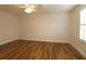 Bright bedroom with wood-look floors and a ceiling fan and shuttered window at 2449 Kingstree Pl, The Villages, FL 32162
