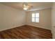 Bedroom features hardwood floors, ceiling fan and window with plantation shutters at 2449 Kingstree Pl, The Villages, FL 32162