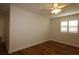 Cozy bedroom featuring hardwood floors, a ceiling fan, and plantation shutters for privacy at 2449 Kingstree Pl, The Villages, FL 32162