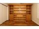 Bedroom with installed wall bookshelf and storage with hard wood floors and a walk in closet at 2449 Kingstree Pl, The Villages, FL 32162