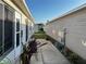 Exterior view features a walkway between homes, enhanced by potted plants at 2449 Kingstree Pl, The Villages, FL 32162