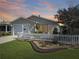 Charming single-story home with a well-manicured lawn, tasteful landscaping and white picket fence at 2449 Kingstree Pl, The Villages, FL 32162