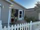 Charming home featuring a well-maintained lawn and a classic white picket fence at 2449 Kingstree Pl, The Villages, FL 32162