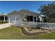Charming home featuring a well-maintained lawn and a classic white picket fence at 2449 Kingstree Pl, The Villages, FL 32162